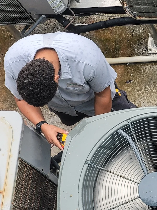 HVAC Technician Diagnosing AC Unit