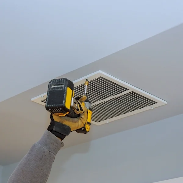 HVAC Technician Installing Ceiling Vent